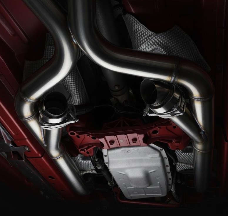 Exhaust cutout kit installed under a car in a studio‑style shot
